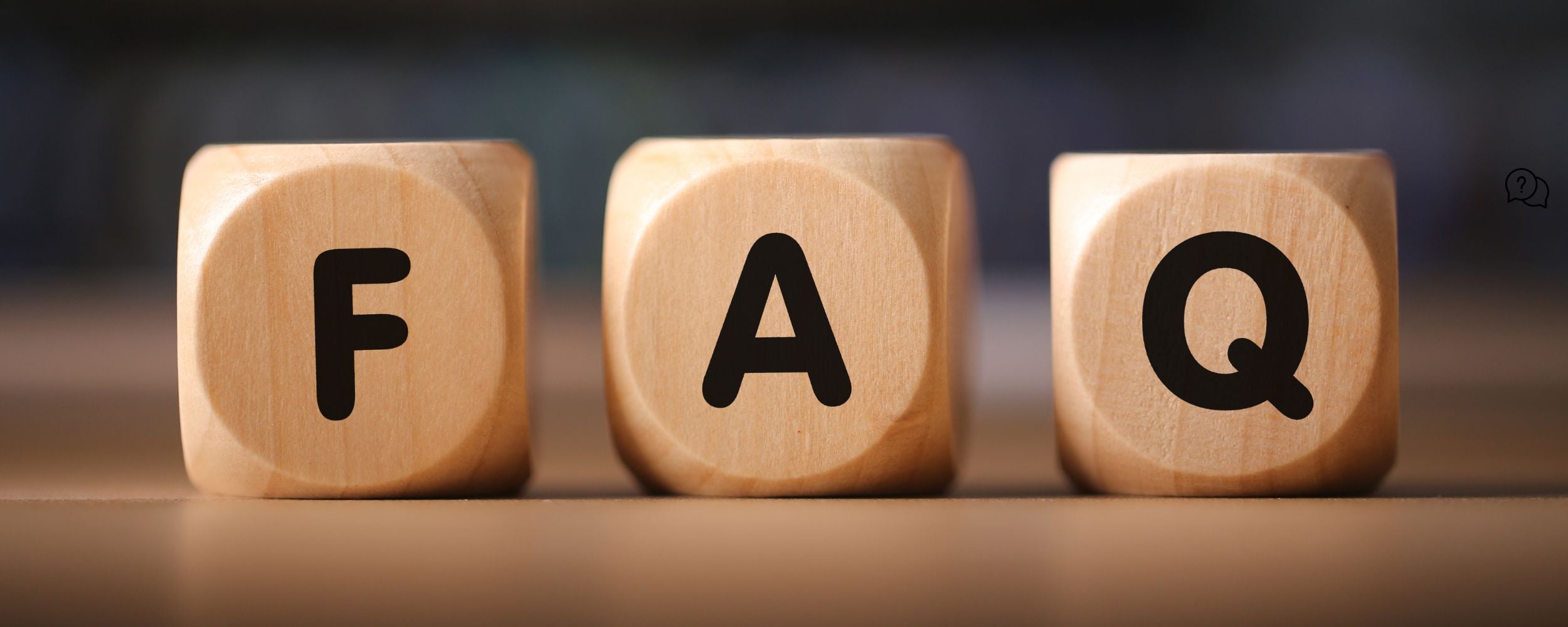 Wooden cubes with letters forming 'FAQ' on a blurred background